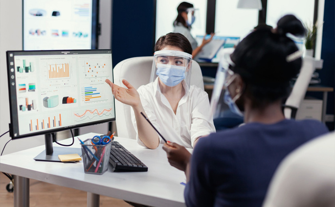 healthcare maintenance analytics healthcare professional and machine woman in mask looking on screen